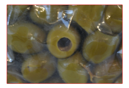 Green pitted olives in a plastic bag